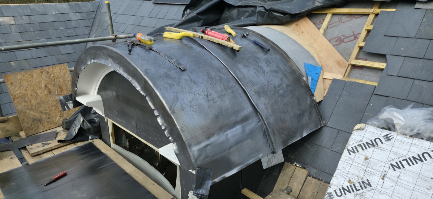 Lead dome dormer being fitted on slate roof