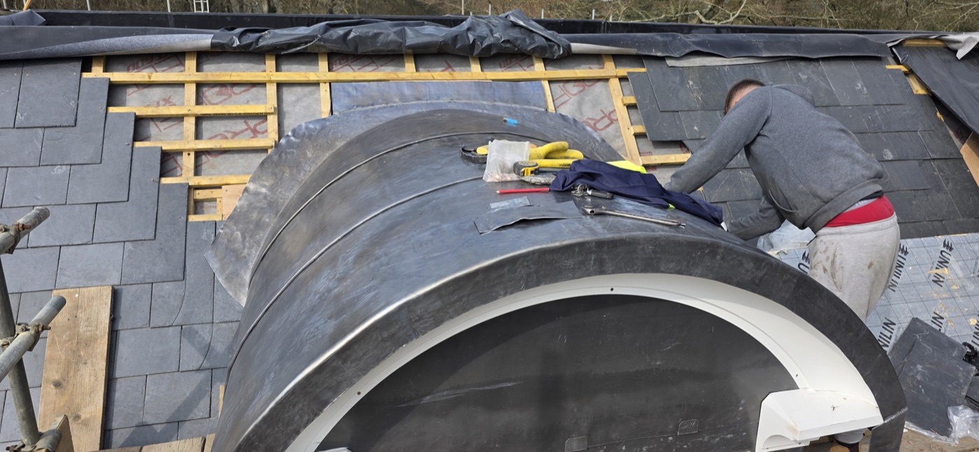 JNC craftsman dressing a bespoke lead dome arch on natural slate