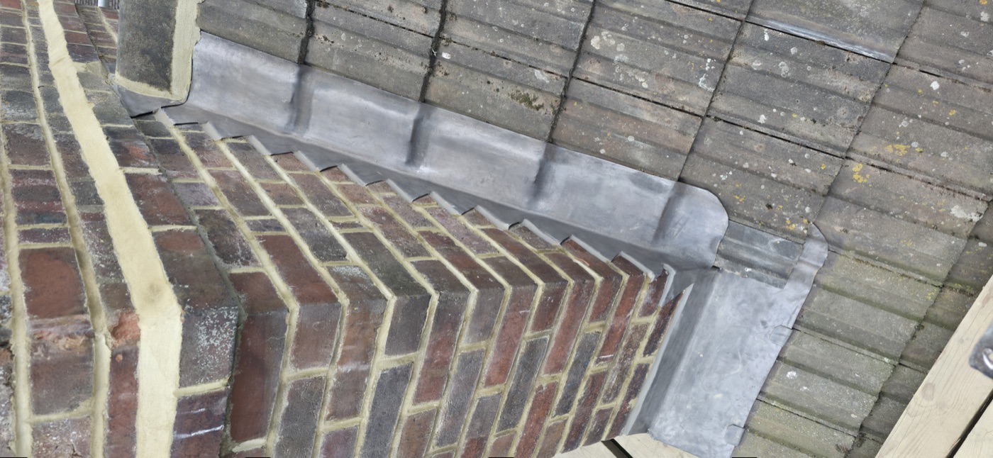 Lead soaker flashing against chimney stack
