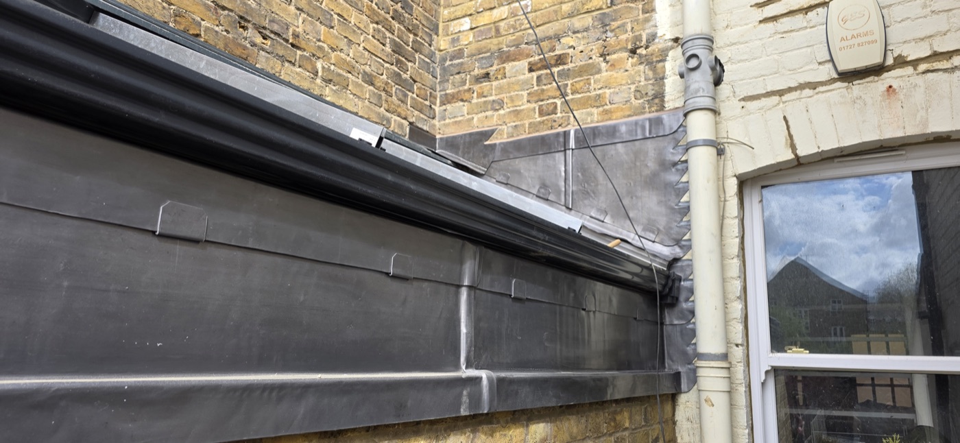 Lead flat roof and gutter on brick building