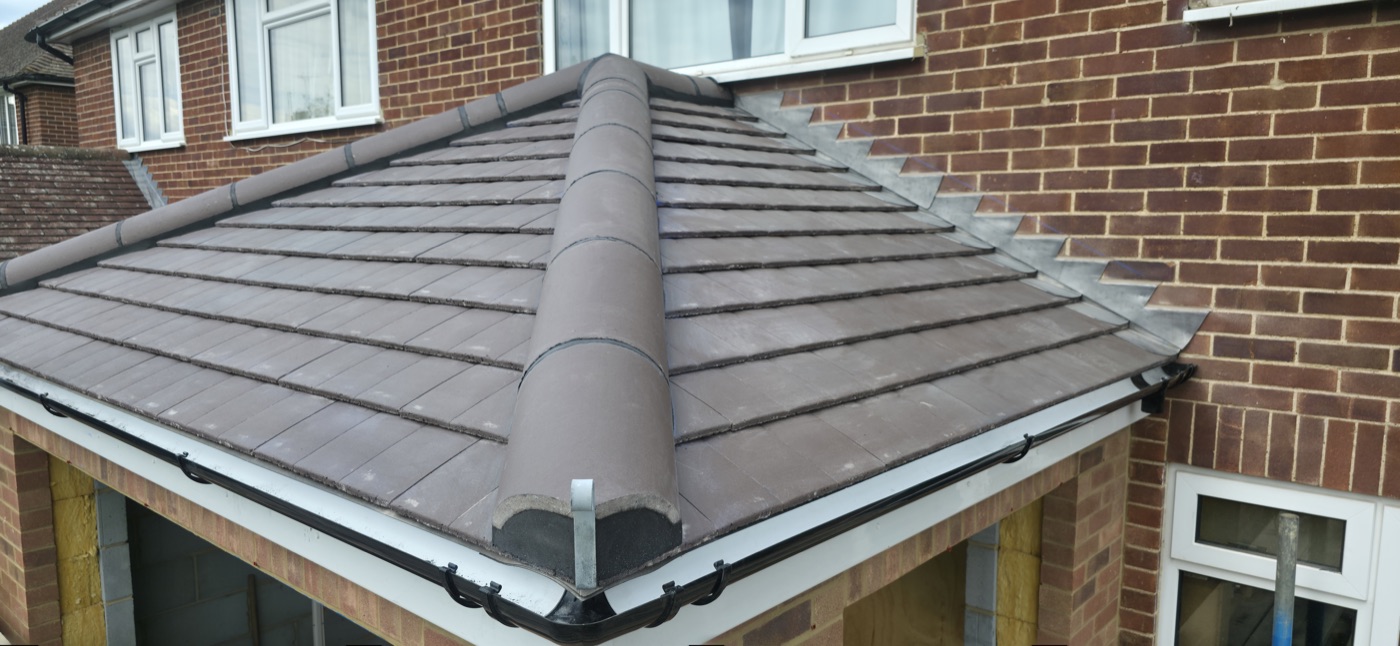 Completed hip roof on brick extension
