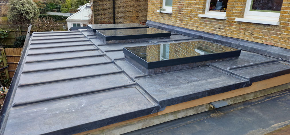 Lead flat roof with modern skylights on extension