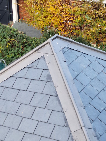 Natural slate pitched roof ridge detail