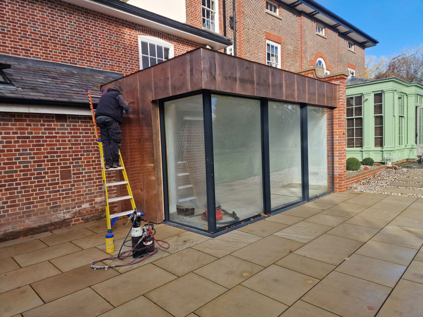 Craftsman installing copper cladding on period estate