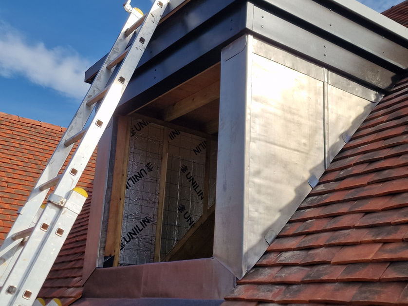 Lead dormer box cladding on red tile roof