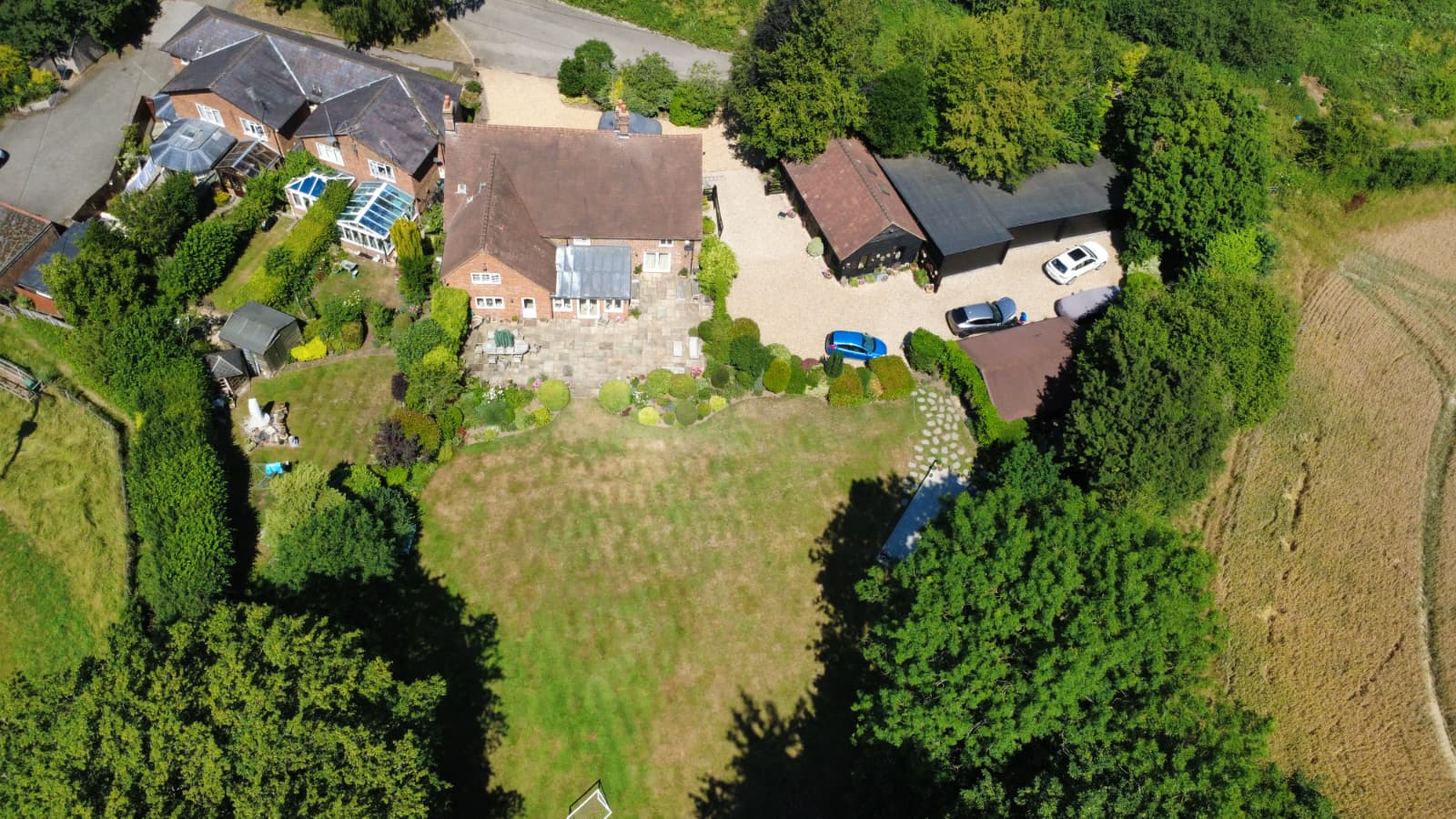 Aerial view of country property and outbuildings during roof works