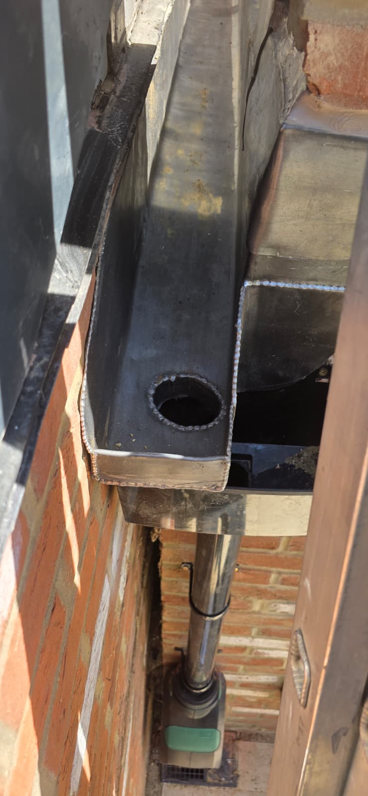 Hand-welded lead box gutter with formed outlet